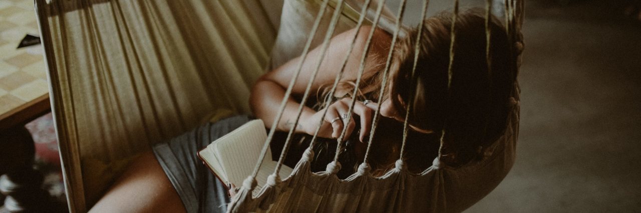 The Mental Health Advice My Mentor Gave That Changed My Life woman reading book while relaxing on hammock