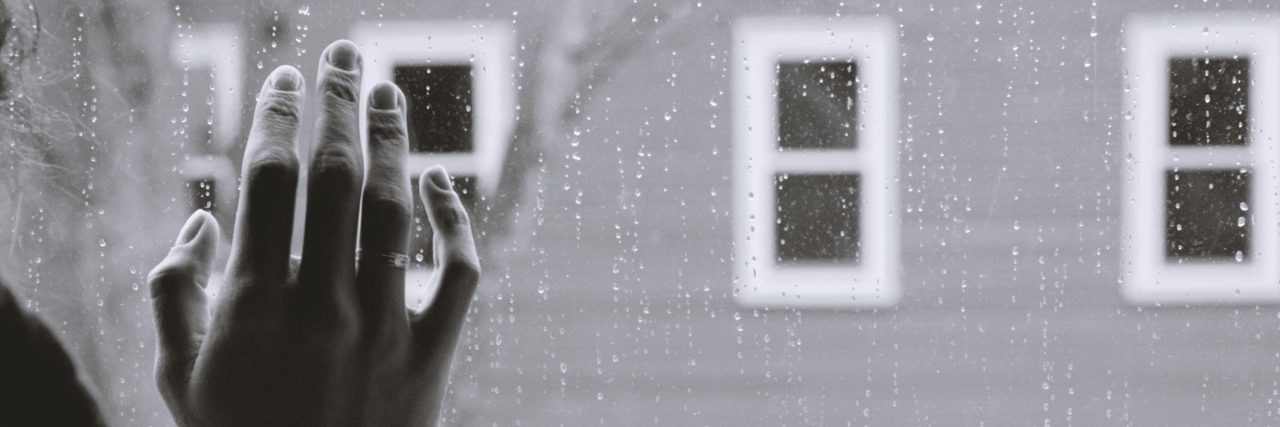 Psychologist Said Psychiatric Hospital Would Ruin My Life black and white photo close up of woman resting hand against window with other windows in background