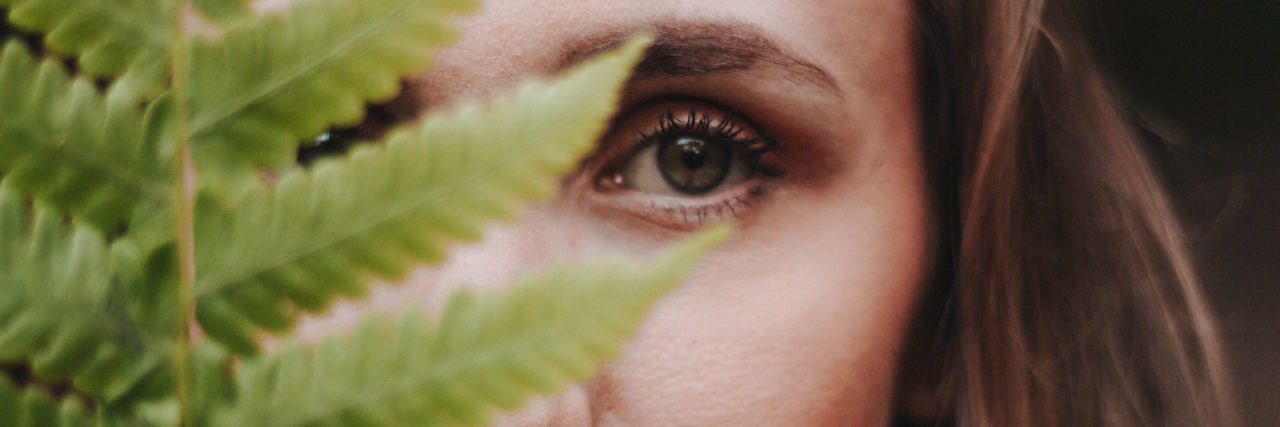 5 Tips for Coping With 'Behind-the-Scenes' Anxiety woman hiding behind leaf