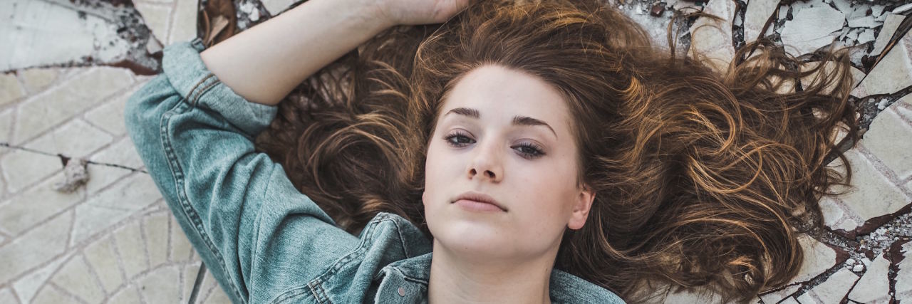 Borderline Personality Disorder: No 'Emotional Skin' woman in front of cracked background