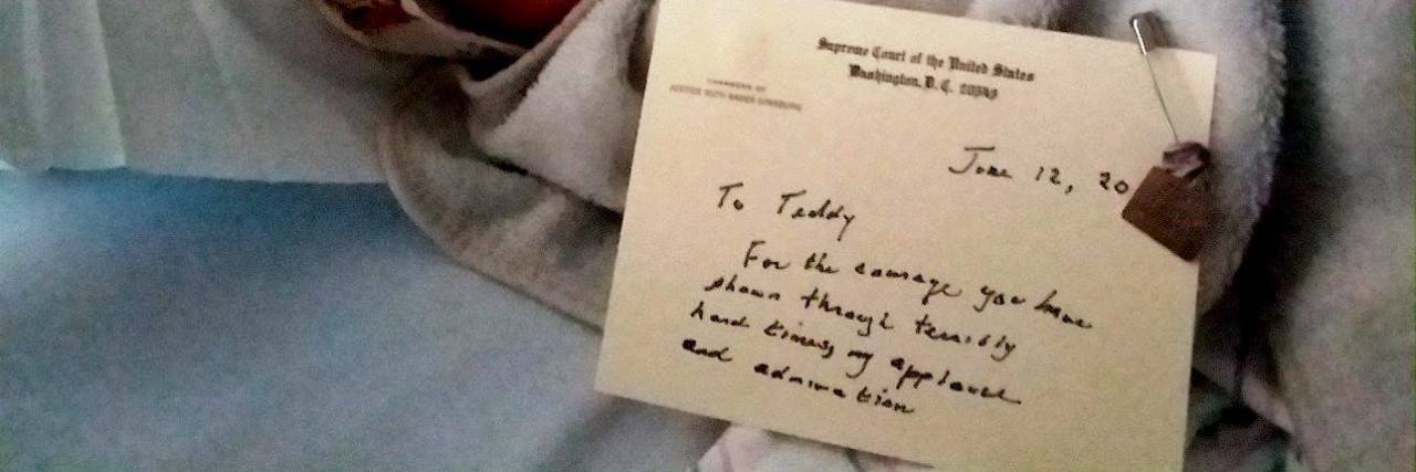 Ruth Bader Ginsburg Sends Note to Child With Rare Disease author's son in a hospital bed with a note from Ruth Bader Ginsburg