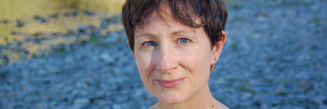 How Meditation Has Helped My Insomnia Caused by Lyme Disease A picture of the writer standing in front of a river.