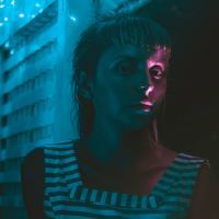 woman with sliver of pink light covered eye
