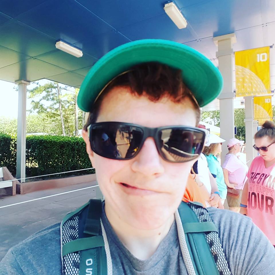 person wearing green hat and sunglasses