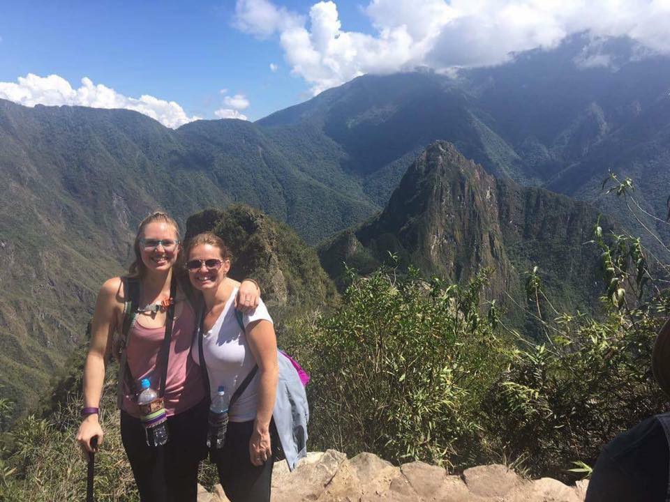 two women posing in front of machu picchu