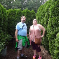 heather ashley and her brother standing among tall shrubs