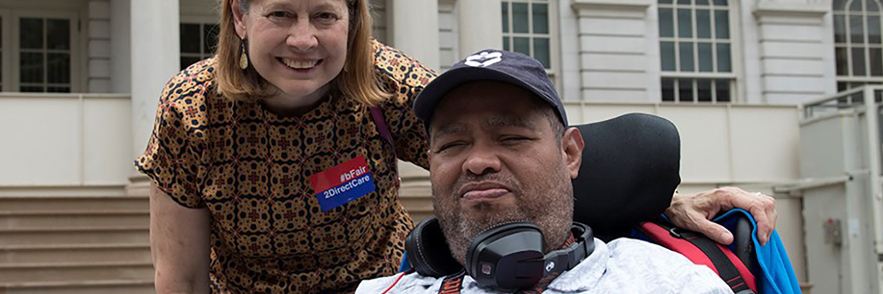 Disability Advocate Gilbert Plaza with HeartShare Executive Director Linda Tempel on the steps of New York City Hall.