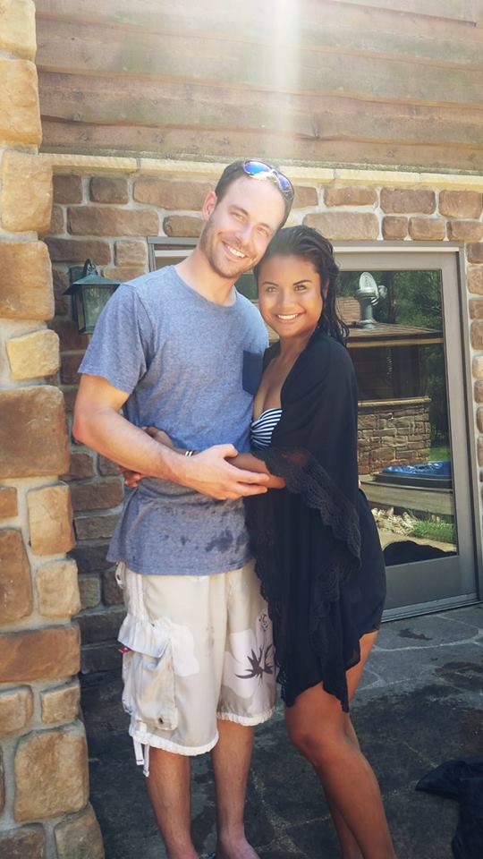 woman and her boyfriend standing outside hugging