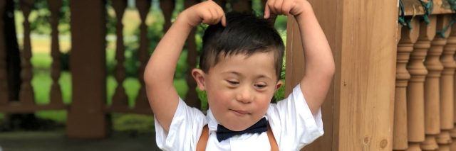 Boy with Down syndrome wearing fancy clothes
