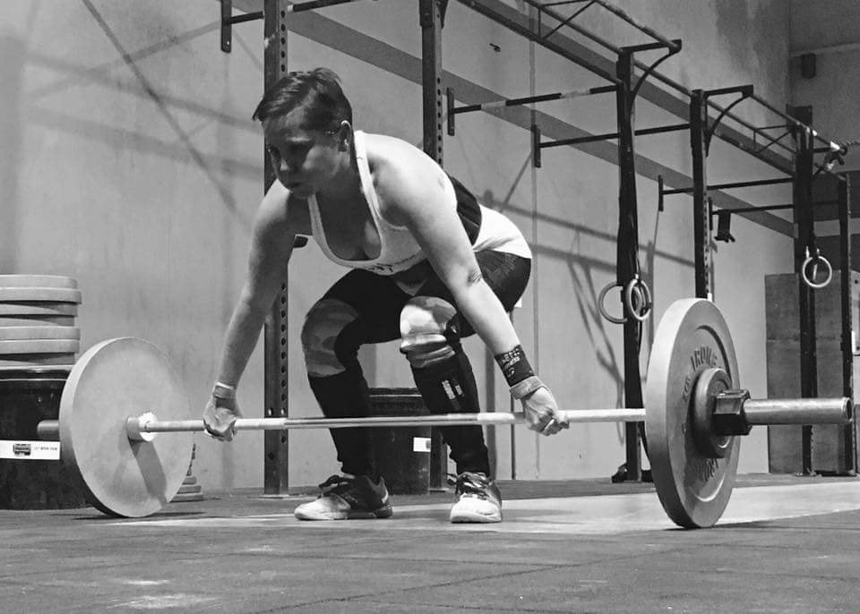 black and white photo of woman lifting weights