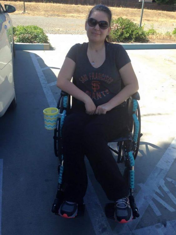 woman using wheelchair decorated with tape and cup holder