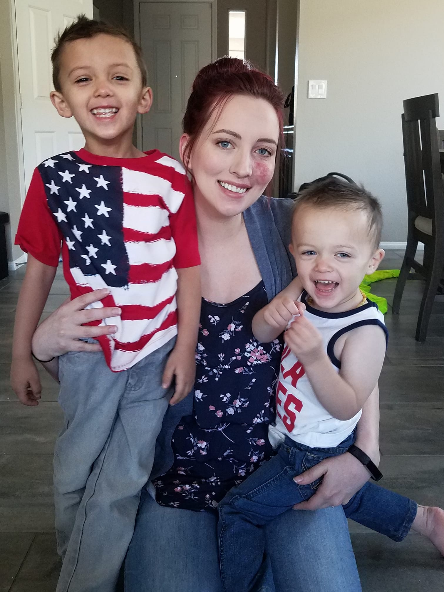 A mom with her birthmark on her cheek and two sons.