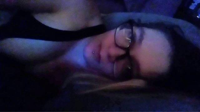 woman lying on her side wearing glasses