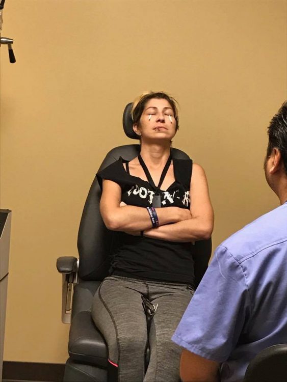 woman sitting in chair doing eye treatment