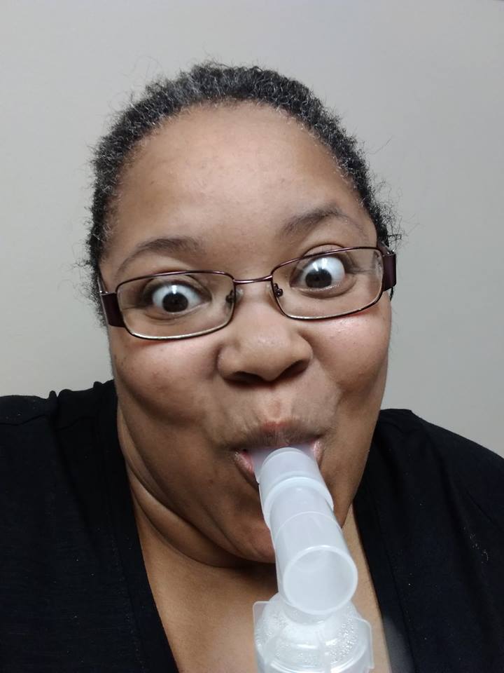 woman making a silly face while receiving breathing treatment