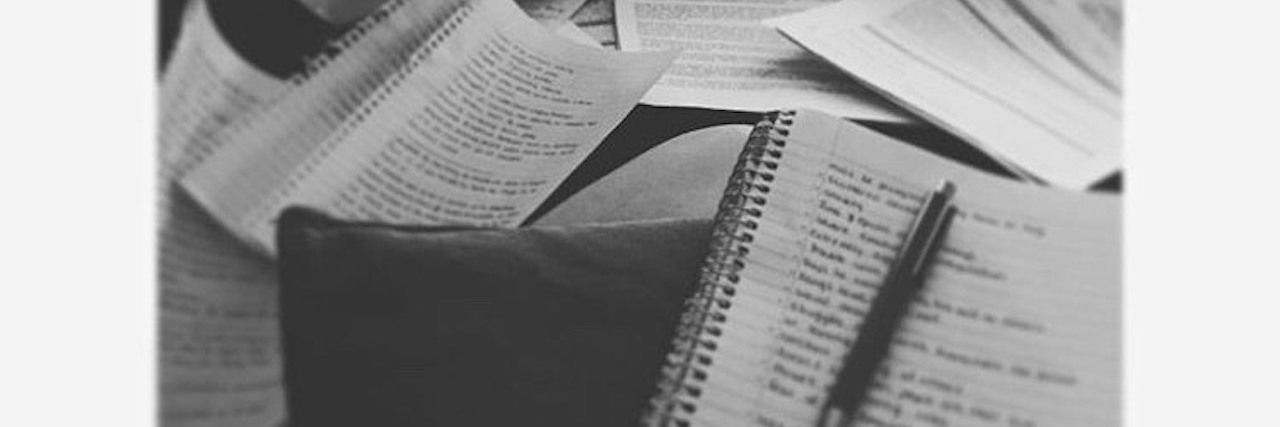 Key Strategies I Learned on the Road to My Child's Autism Diagnosis Black and white image of notes, papers, notebooks, etc.