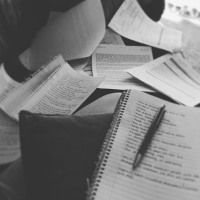 Black and white image of notes, papers, notebooks, etc.