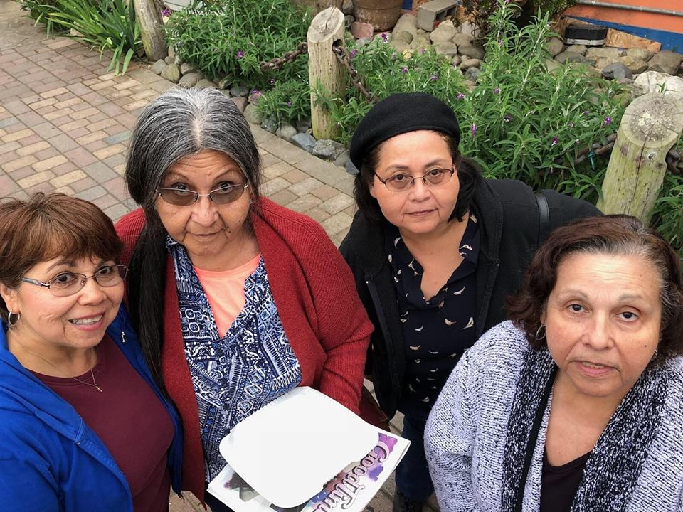 four sisters smiling outside