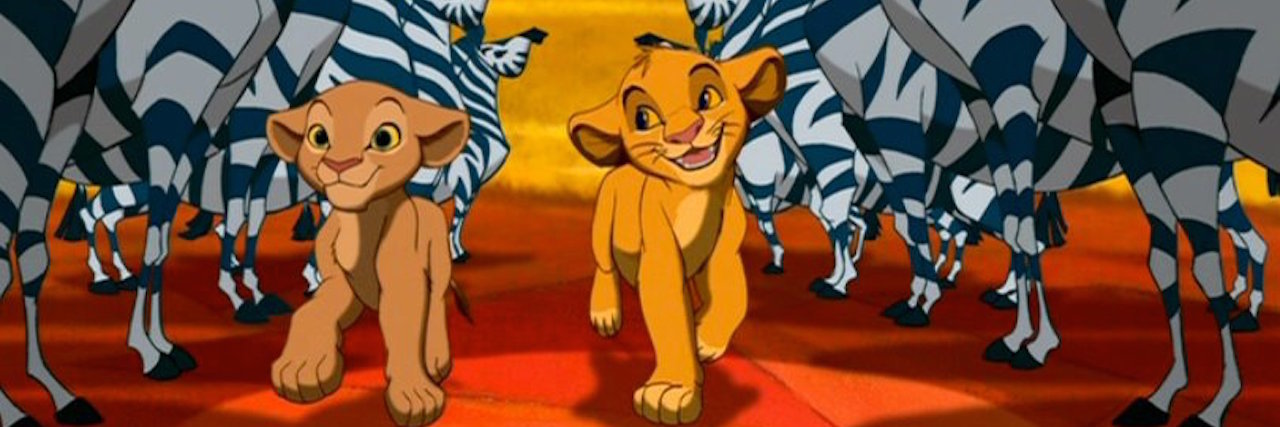 A graphic from "The Lion King" of Simba and his friend walking between two rows of zebras.