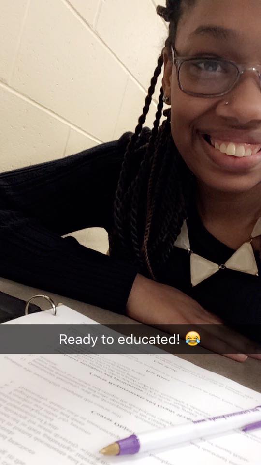 woman sitting at a desk with a caption 'ready to be educated'