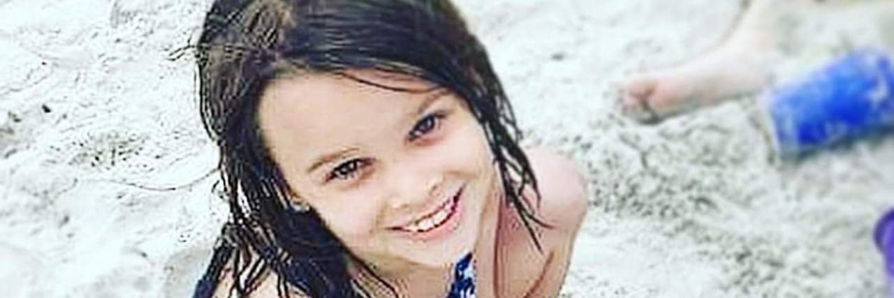 Letter to PANDAS from a Parent author's daughter playing in the sand