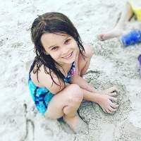 author's daughter playing in the sand