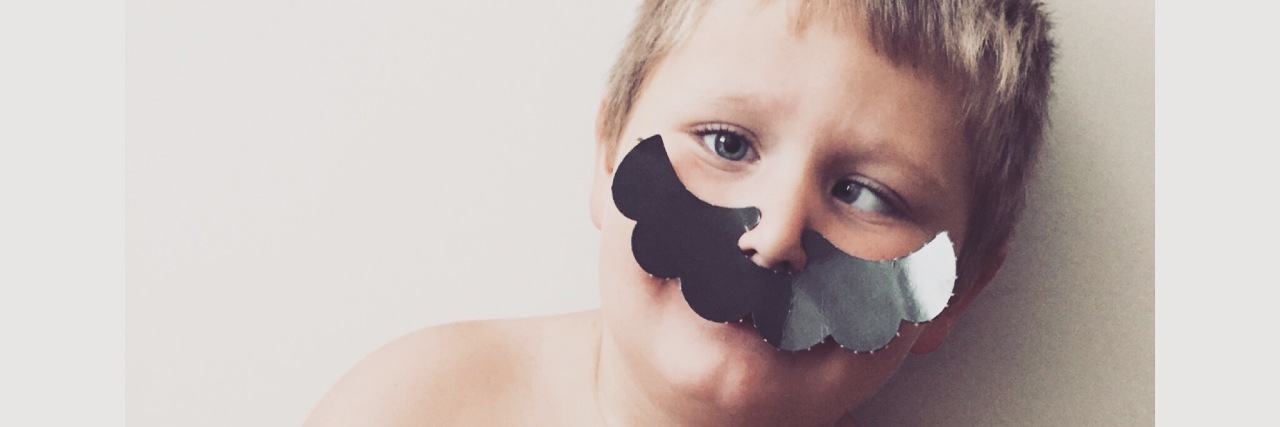 When I Recognized My Son on the Autism Spectrum Was 'Masking' Boy wearing a fake mustache and holding his guinea pig