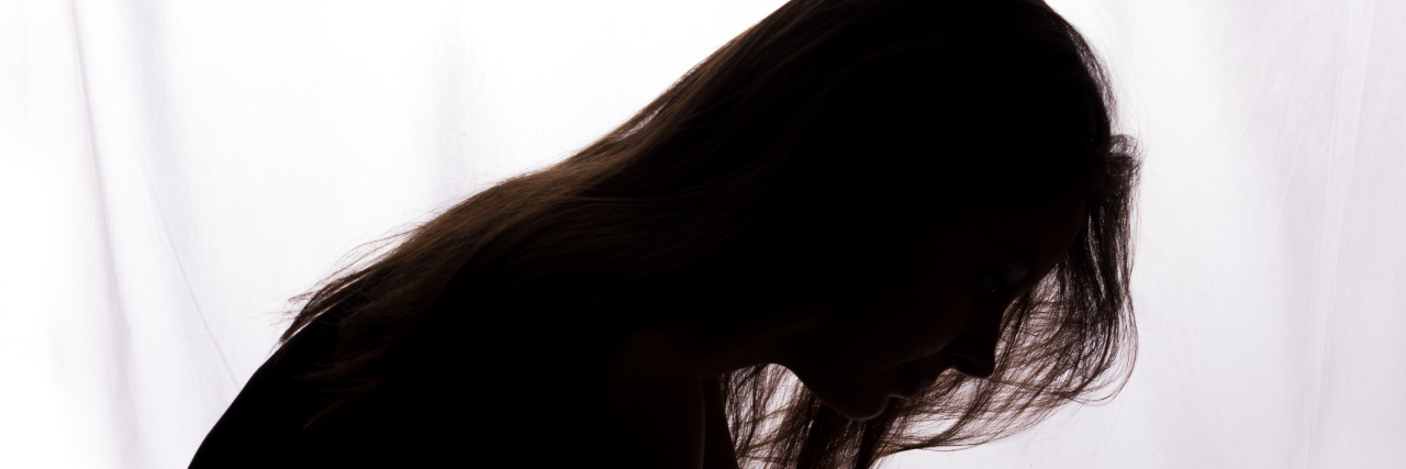 The Day I Entered the Mind of My Abuser silhouette of a sad woman looking down