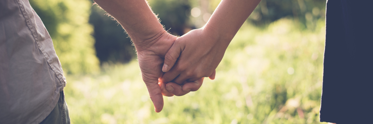 Finding Love as a Couple With Disabilities Couple holding hands.