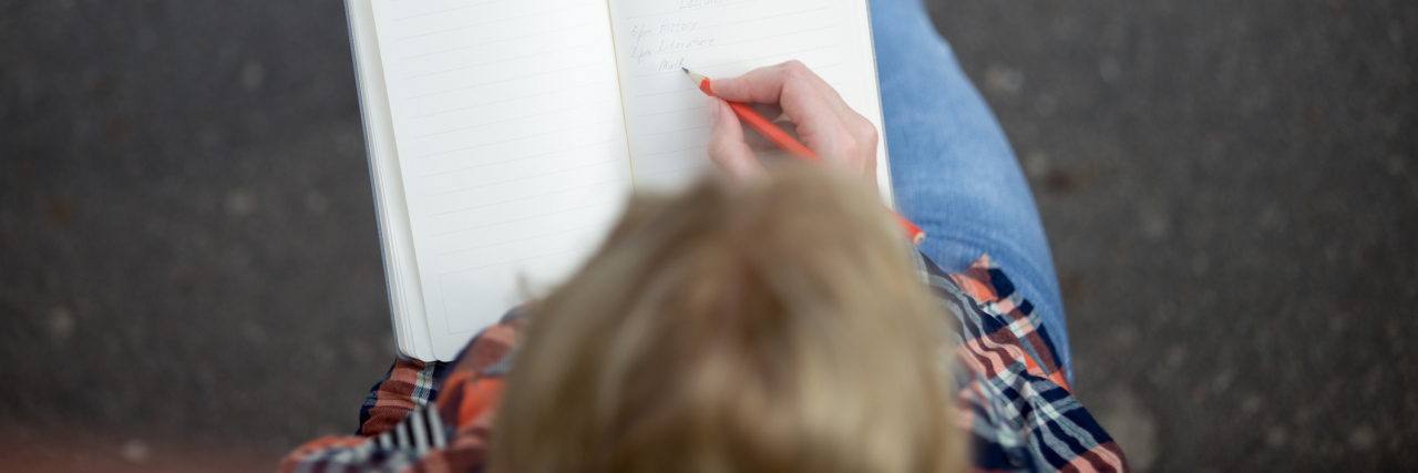 Dear Prednisone, I Would Not Be Where I Am Today Without You A picture of a woman writing in a notebook.