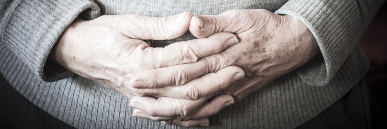 A Letter From a Bereaved Mother About the Pain of Pregnancy Loss Woman's hands folded over her belly.