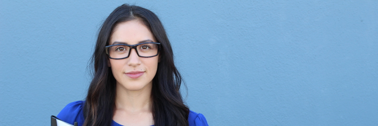 Do I Need a Psychologist or a Psychiatrist? Stock image of female college student isolated