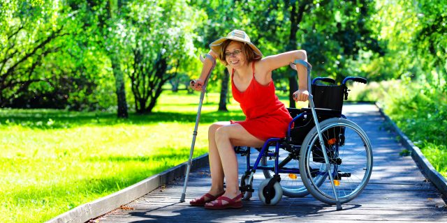 Woman gets up from a wheelchair.