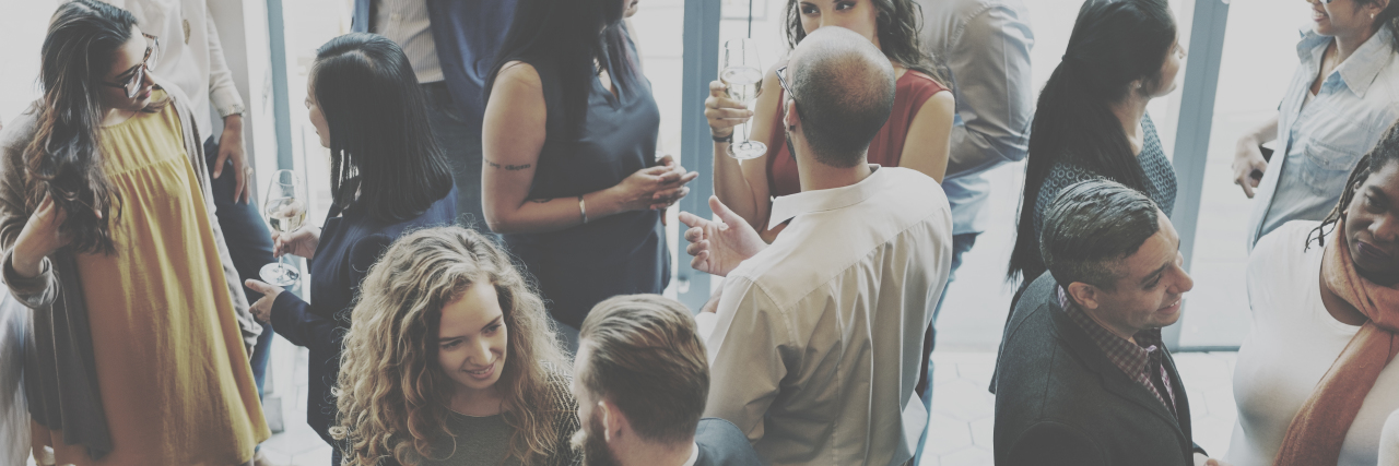 Why I View My Stuttering as a Gift to Help Others A group of people are standing around talking to each other.