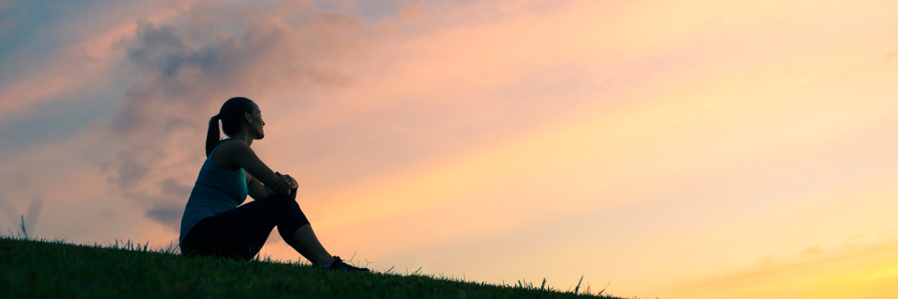 Disability Isn’t Always What You May Think Woman watching sunset.