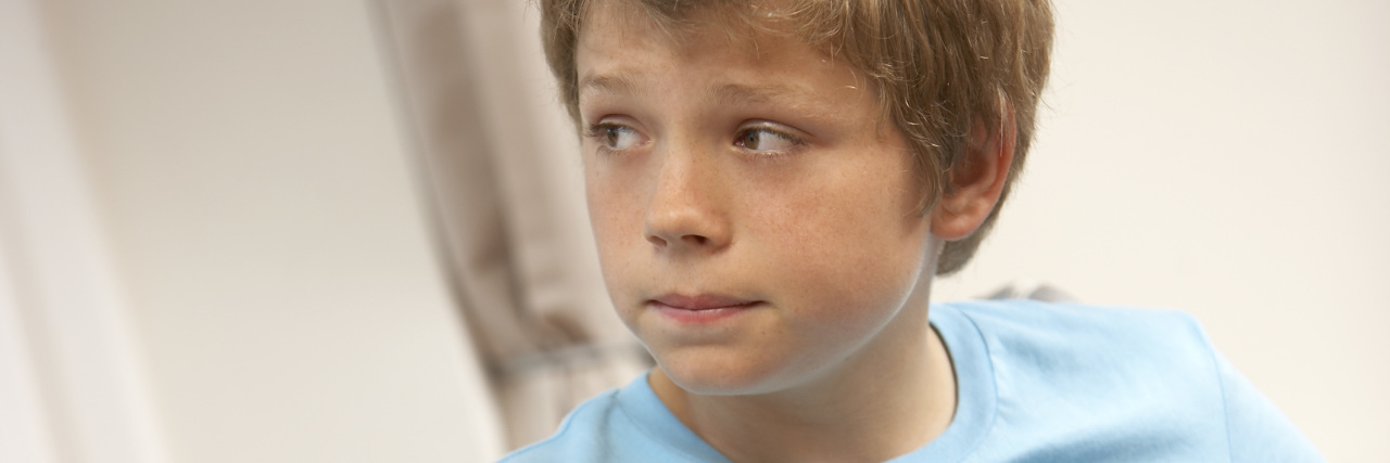 Reflecting on the Bullying I Experienced Growing Up With a Disability Teen boy in wheelchair looking worried..