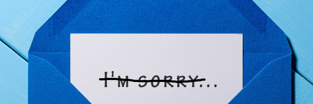 Greeting card with "I'm sorry" crossed out.