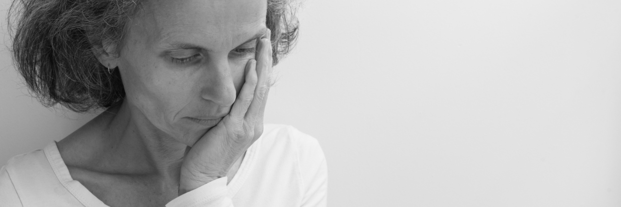 Do Fibromyalgia Symptoms Worsen Over Time? black and white photo of woman looking away