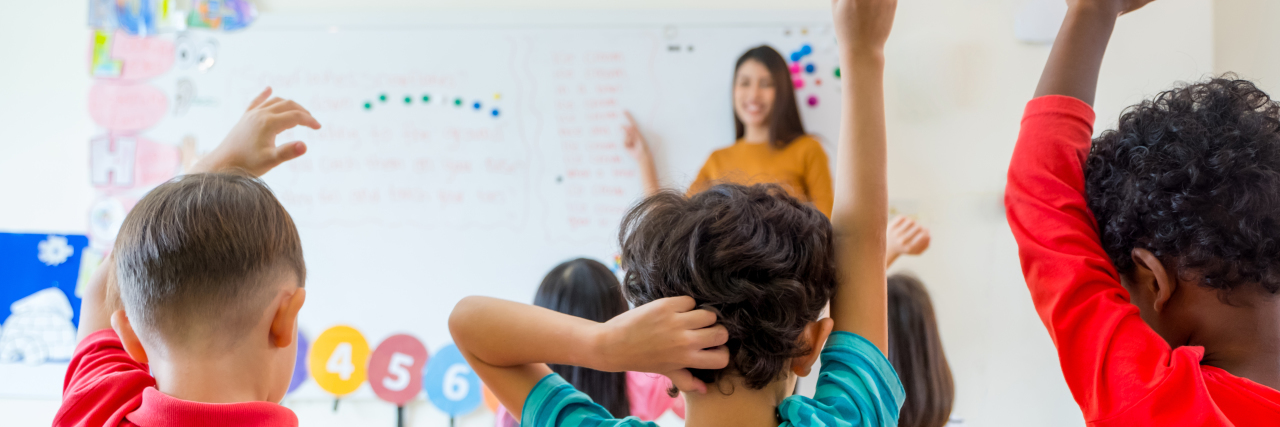 Letter to Teachers of Medically Fragile Students and Their Siblings Preschool kid raise arm up to answer teacher question on whiteboard in classroom,Kindergarten education concept