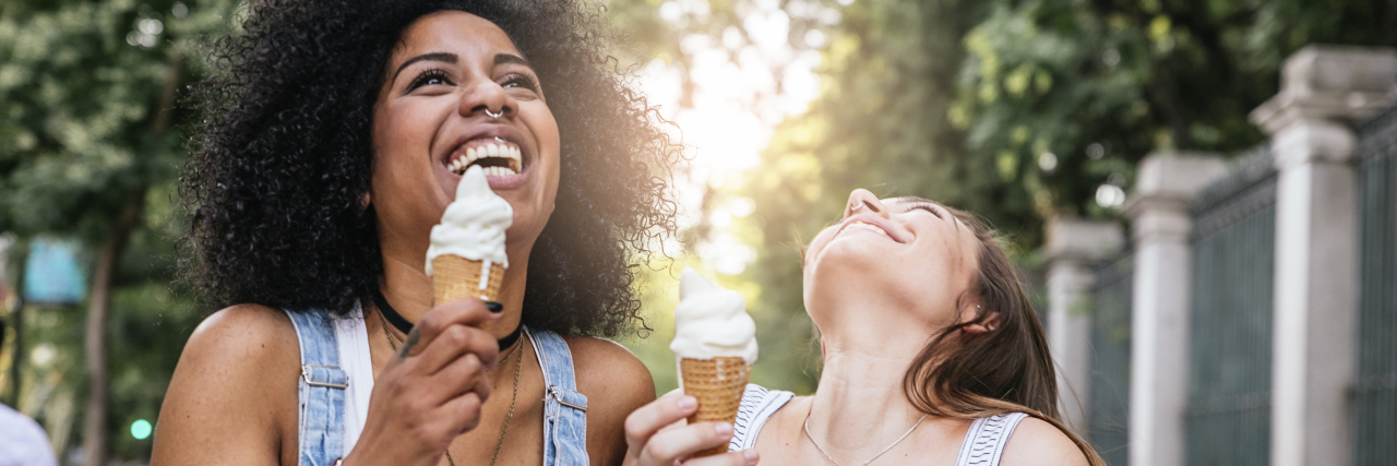 Two female friends eating ice cream.