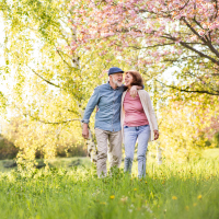A picture of a couple walking in a park.