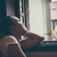 woman looking out window, sad, thoughtful