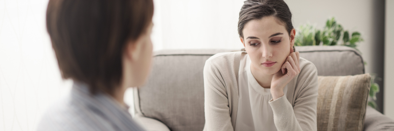 The Question That Made Me Rethink My Undiagnosed Illness Battle A young female talking to a therapist.