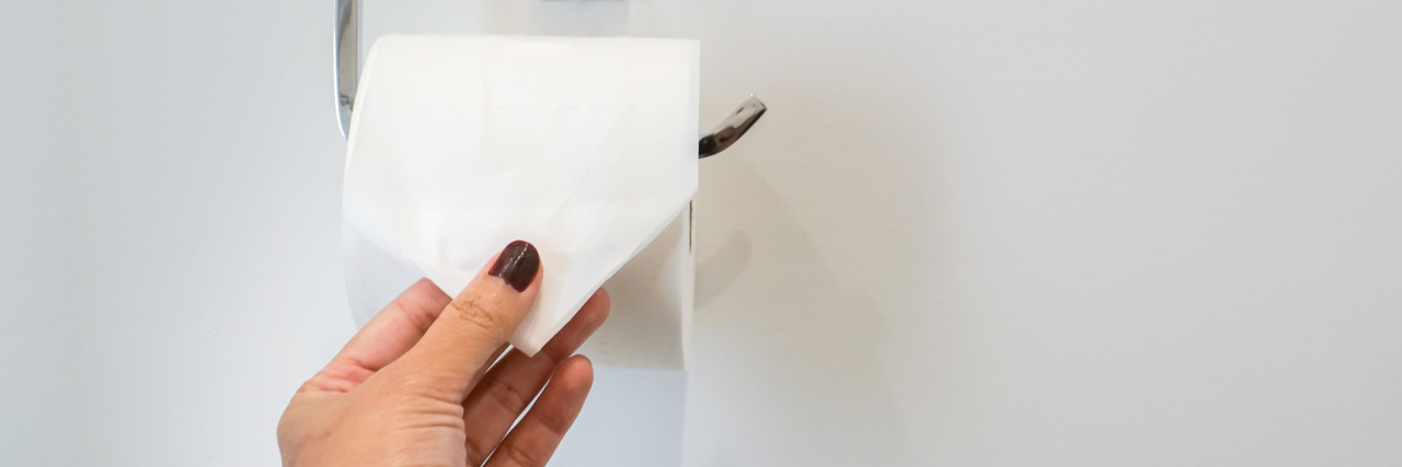 4 Ways to Prep for Your Colonoscopy Prep A close-up of a woman pulling on toilet paper.