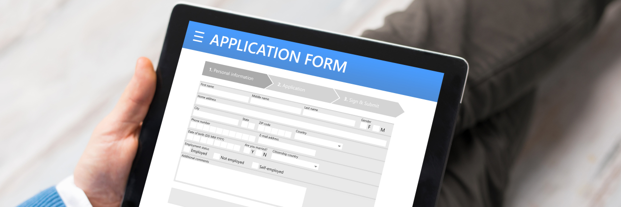 Applying for a Job as a Person With Autism Man applying for job on tablet.