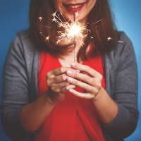 A picture of a woman holding a sparkler.