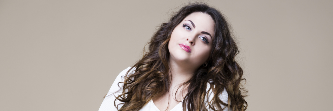 Why I've Used My Eating Disorder to Cope With My Chronic Pain A picture of a woman looking into the camera.