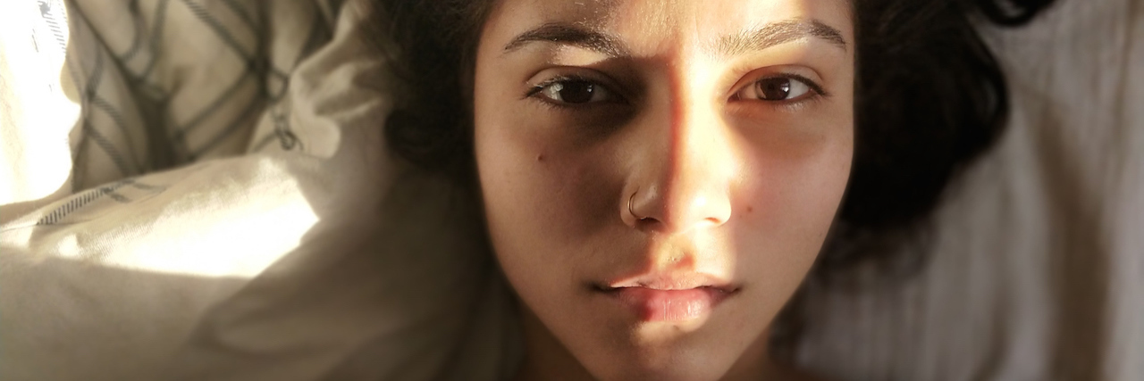 What 'Choose Happiness' Means to Someone With Depression Woman laying in bed