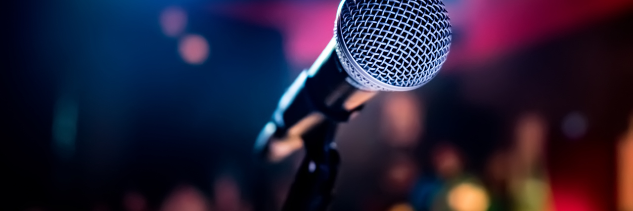 A Letter to the Microphone, From a Person Who Stutters Close-up of a microphone on a stage.