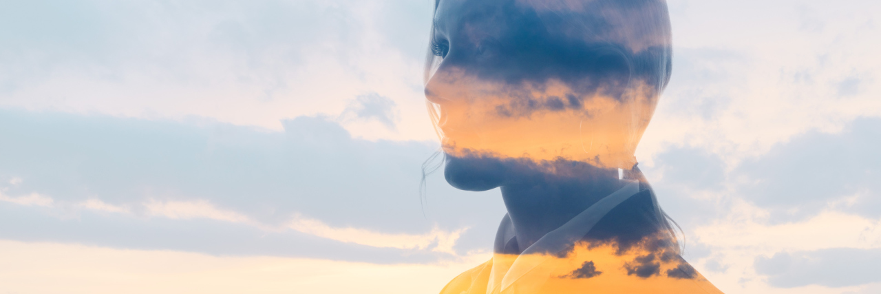 double exposure of a woman and a sunset